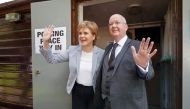 In this file photo taken on June 23, 2016 Scotland's First Minister and Leader of the Scottish National Party (SNP), Nicola Sturgeon (left) and her husband Peter Murrell, react as leave after casting their votes at a polling station at Broomhouse Community Hall in east Glasgow, as Britain holds a referendum on whether to stay or leave the European Union (EU). (Photo by Robert Perry / AFP)