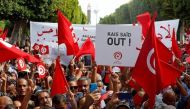 Supporters of Tunisia's opposition party Ennahda carry signs and flags during a protest against Tunisian President Kais Saied in Tunis, Tunisia, October 15, 2022. (REUTERS/Zoubeir Souissi)