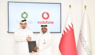 Vodafone Qatar and Msheireb Smart City officials exchange the agreement.