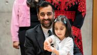 Newly elected leader of the Scottish National Party, Humza Yousaf poses with his daughter Amal after signing the nomination form to become First Minister for Scotland, at the Scottish Parliament in Edinburgh, on March 28, 2023 ahead of the MP's vote concerning his nomination to be Scotland's sixth First Minister. (Photo by Jane Barlow / POOL / AFP)