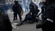 French anti-riot police forces detain a protestor during a demonstration after the government pushed a pensions reform through parliament without a vote, in Paris on March 28, 2023. (Photo by Christophe Archambault / AFP)