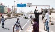 Protesters gather at a road block on a highway in Dakar on March 30, 2023. - Senegal, a rare island of stability in the troubled West African region, is seeing another tense week with the resumption of the libel trial against Ousmane Sonko on Thursday. Sonko and his supporters accuse the government of using the justice system to prevent him from running in next year's presidential election. (Photo by GUY PETERSON / AFP)