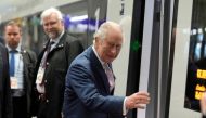 Britain's King Charles III boards a train on a way to Hamburg at the main train station in Berlin, on March 31, 2023. Photo by Markus Schreiber / POOL / AFP