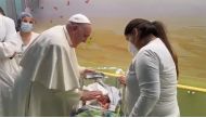 This photo grabbed from a video taken and handout by The Vatican Media on March 31, 2023 shows Pope Francis baptising a baby boy named Miguel Angel, while visiting children at the oncology ward of the Gemelli hospital in Rome, the same hospital where the Pope was admitted to another ward on March 29 for bronchitis. (Photo by Handout / VATICAN MEDIA / AFP) 