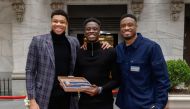 (Left to right) Professional basketball players Giannis Antetokounmpo, Alex Antetokounmpo, Thanasis Antetokounmpo pose for a photo before ringing the closing bell at New York Stock Exchange on March 31, 2023 in New York City. Mike Coppola/Getty Images/AFP