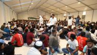 People gather inside an Iftar tent set up by the Awqaf Ministry near Thursday & Friday Souq in Ain Khaled. Pic: Salim Matramkot / The Peninsula