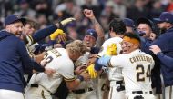 Garrett Mitchell #5 of the Milwaukee Brewers celebrates with his teammates after hitting a walk-off solo home run against the New York Mets in the ninth inning at American Family Field on April 05, 2023 in Milwaukee, Wisconsin. (Photo by Patrick McDermott / GETTY IMAGES NORTH AMERICA / Getty Images via AFP)