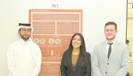 Yaqoub Jassim Al Jaidah, Myra Abbasi and Ubaida Al Aani presenting a poster on the inhibitory effect of Cambodian agarwood oud oil.  