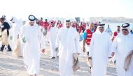 Minister of Environment and Climate Change H E Sheikh Dr. Faleh bin Nasser bin Ahmed bin Ali Al Thani (third right) and other officials during a beach clean-up, at Fuwairit Beach. 