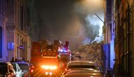 Rescue vehicles gather at the scene where a building collapsed in the southern French port city of Marseille early on April 9, 2023. (Photo by Nicolas Tucat / AFP)