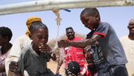 Children at a water project executed by Qatar Red Crescent Society.