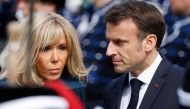 French President Emmanuel Macron and his wife Brigitte Macron are seen during a welcoming ceremony in The Hague on April 11, 2023 as part of a state visit to the Netherlands. (Photo by Ludovic Marin / AFP)