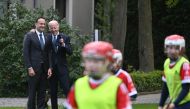 Ireland's Prime Minister Leo Varadkar (left) and US President Joe Biden chat as they watch school children playing Gaelic sports in the field behind Farmleigh House, in Dublin, on April 13, 2023, during his four-day trip to Northern Ireland and Ireland commemorating the 25th anniversary of the 