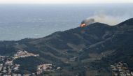 A forest fire burns on a hill overlooking the village of Banyuls-sur-Mer, southwestern France on April 16, 2023. Photo by RAYMOND ROIG / AFP
