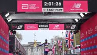 Kenya's Kelvin Kiptum breaks the tape to win the Men's race at the finish of the 2023 London Marathon in central London on April 23, 2023. Photo by JUSTIN TALLIS / AFP) 
