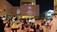 People enjoy a music performance at Msheireb Downtown Doha. 