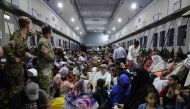 A handout picture released by the British Ministry of Defence (MOD) on April 27, 2023, and taken on April 26, shows British Nationals onboard an RAF aircraft in Sudan, during evacuation to Larnaca International Airport in Cyprus. (Photo by Arron Hoare / MOD / AFP)