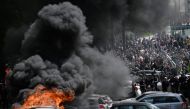 Cars are set on fire during a demonstration on May Day (Labour Day), to mark the international day of workers, more than a month after the government pushed an unpopular pensions reform act through parliament, in Nantes, northwestern France, on May 1, 2023. (Photo by LOIC VENANCE / AFP)