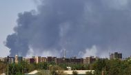 Smoke billows over buildings in Khartoum on May 1, 2023 as deadly clashes between rival generals' forces have entered their third week. (Photo by AFP)