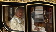 Britain's King Charles III and Britain's Camilla, Queen Consort begin their journey in the Diamond Jubilee State Coach (Photo by Marco BERTORELLO / AFP)