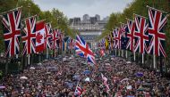 Well-wishers gather on The Mall to celebrate Britain's King Charles III and Britain's Queen Camilla, in central London, on May 6, 2023 following of their coronations. Photo by Marco BERTORELLO / AFP