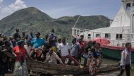 Flood-affected residents wait for the distribution of aid from the central government of the Democratic Republic of Congo, four days after floods and landslides triggered by heavy rains killed at least 400, in Nyamukubi, eastern Democratic Republic of Congo, on May 9, 2023. Photo by Guerchom Ndebo / AFP