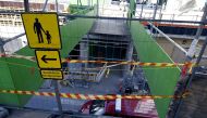 Barrier tape is fixed at the site of an accident in which around 27 people, a majority of them children, were injured on May 11, 2023 in Espoo, Finland, when a pedestrian bridge collapsed. (Photo by Jussi Nukari / Lehtikuva / AFP) 
