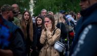 A woman reacts during the funeral ceremony of Ukrainian serviceman Valerii Sosnovskii who died near Bakhmut, Donetsk region in Poltava on May 11, 2023, amid the Russian invasion of Ukraine. (Photo by Ihor Tkachov / AFP)