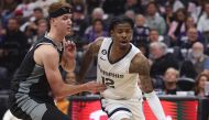 File photo: Ja Morant (R) seen in action with his team the Memphis Grizzlies. Lachlan Cunningham/ AFP