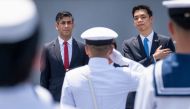Britain's Prime Minister Rishi Sunak (L) and Japan's State Minister of Defence Toshiro Ino inspect the guard of honour on board the Japanese aircraft carrier JS Izumo during a visit to the Japan Maritime Self-Defence Force (JMSF) at the Yokosuka Naval Base in Yokosuka, ahead of the G7 Leaders' Summit, on May 18, 2023. (Photo by Stefan Rousseau / POOL / AFP)
