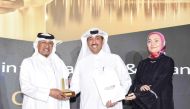 QNB officials receiving 'Best CSR bank' award at the Qatar CSR Summit 2023.
