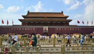 People are seen next to the Tiananmen Gate in Beijing on June 3, 2023, a day before the anniversary of the 1989 Tiananmen crackdown. (Photo by Hector RETAMAL / AFP)