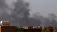 Smoke billows over south Khartoum after more than a month of deadly fighting between forces loyal to two rival generals. (File photo by AFP)