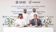 Officials of QNB and CWallet during the signing ceremony.