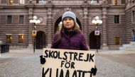 A file photo taken on November 19, 2021 shows Swedish climate activist Greta Thunberg as she poses for a picture holding a sign reading 