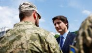 Canadian Prime Minister Justin Trudeau speaks with Ukrainian soldiers as he visits an exhibition of destroyed military vehicles in Kyiv on June 10, 2023. (Photo by Valentyn Ogirenko / AFP)