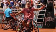 Japan's Tokito Oda (C) celebrates after winning against Britain's Alfie Hewett during their men's wheelchair singles final match on day fourteen of the Roland-Garros Open tennis tournament at the Court Philippe-Chatrier in Paris on June 10, 2023. (Photo by Thomas SAMSON / AFP)