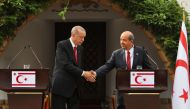 Turkish President Recep Tayyip Erdogan (left) shakes hands with the leader of the self-proclaimed Turkish Republic of Northern Cyprus, Ersin Tatar, during an official visit in Nicosia, on June 12, 2023. (Photo by Birol Bebek / AFP)