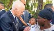 A handout picture provided by the Tunisian Presidency Press Service on June 10, 2023, shows President Kais Saied speaking with migrants from sub-Saharan African countries during a visit to Sfax. (Photo by Tunisian Presidency / AFP)