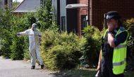 A police forensics officer conducts a search on Ilkeston Road in Nottingham, central England (Photo by Darren Staples / AFP)