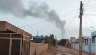 Smoke billows in the distance amid ongoing fighting in Khartoum on June 13, 2023. (Photo by AFP)