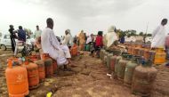 Sudanese wait for a gas truck to arrive to exchange their empty canisters, in Wad Madani, the capital of Sudan's al-Jazirah state, on June 14, 2023. (Photo by AFP)
