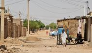 A man walks in a street in Khartoum on June 19, 2023. (Photo by AFP)