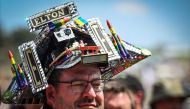A festival goer wears a Elton John themed hat on day 5 of the Glastonbury festival in the village of Pilton in Somerset, southwest England, on June 25, 2023. (Photo by Oli Scarff / AFP)