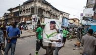 Supporters of the President of Sierra Leone and Leader of Sierra Leone People party (SLPP), Julius Maada Bio, celebrate in the streets following his re-election in Freetown in June 27, 2023. (Photo by JOHN WESSELS / AFP)