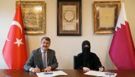 President of Ibn Khaldun University Dr. Atilla Arkan (left) and Dr. Hayat Abdullah Maarafi, Executive Director of QatarDebate, during the signing ceremony.