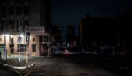 File Photo: An illuminated signboard on display outside the Eskom Regional Office in Braamfontein, Johannesburg during load-shedding (rolling blackout) on 31 January, 2023. (AFP)