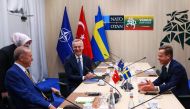 NATO Secretary-General Jens Stoltenberg (top center), Turkish President Tayyip Erdogan and Swedish Prime Minister Ulf Kristersson (right) during a meeting, on the eve of a NATO summit, in Vilnius on July 10, 2023. (Photo by Yves Herman / AFP)