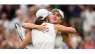 kraine's Elina Svitolina (R) hugs Poland's Iga Swiatek after winning their women's singles quarter-finals tennis match on the ninth day of the 2023 Wimbledon Championships at The All England Tennis Club in Wimbledon, southwest London, on July 11, 2023. (Photo by Daniel LEAL / AFP)