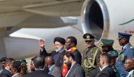 Zimbabwe President Emmerson Mnangagwa (C-R) looks on as he welcomes Iranian President Ebrahim Raisi (C-L) who arrived on a state visit at the Robert Gabriel Mugabe International Airport in Harare on July 13, 2023. (Photo by Jekesai NJIKIZANA / AFP)
